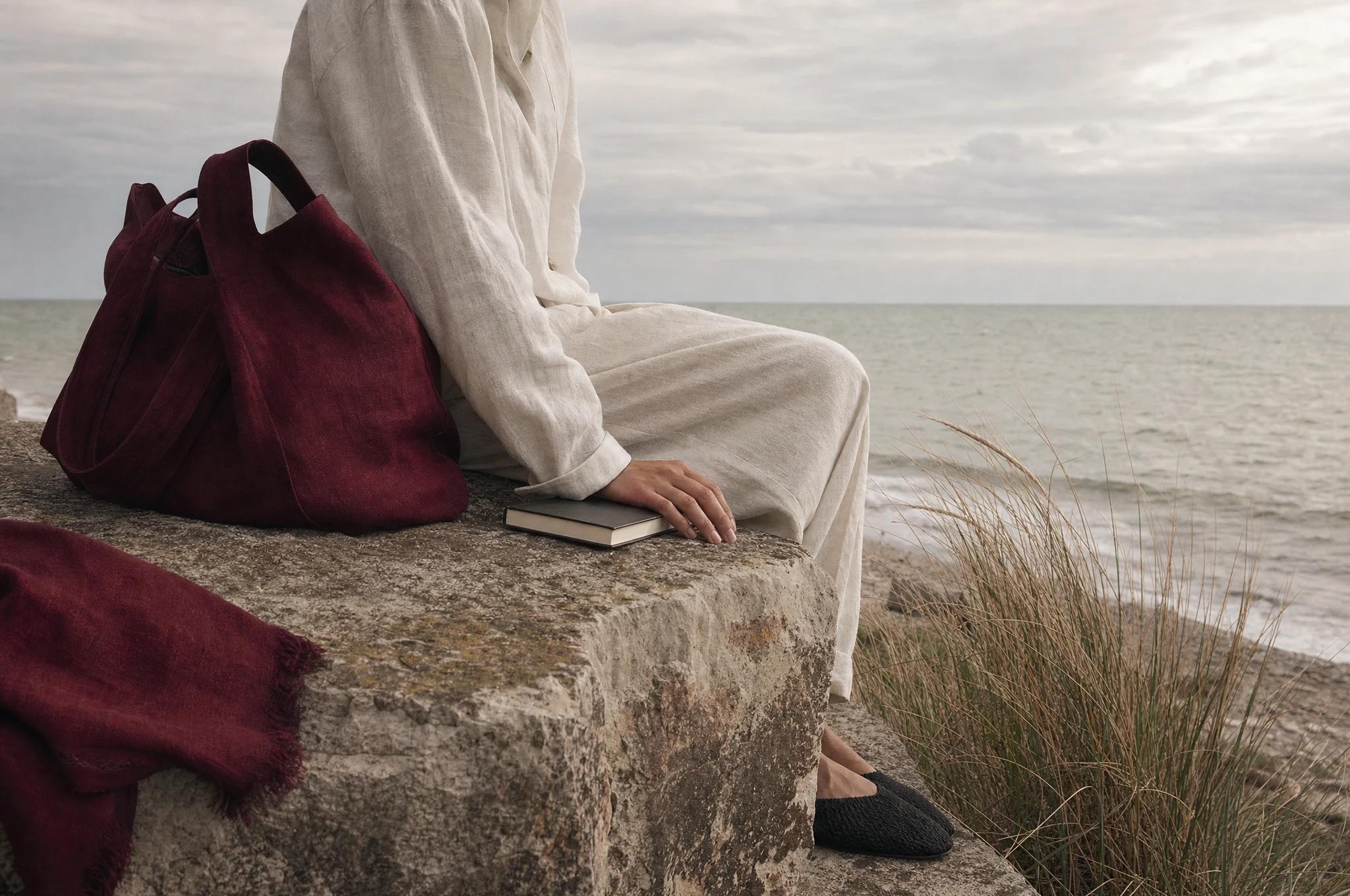 Coastal lifestyle concept, with pearl linen and a burgundy bag